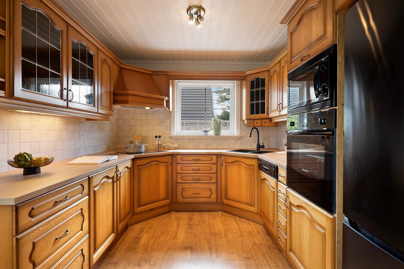 Her er hvitevarer som stekeovn, platetopp, oppvaskmaskin og mikrobølgeovn integrert for et helhetlig uttrykk Galleribilde