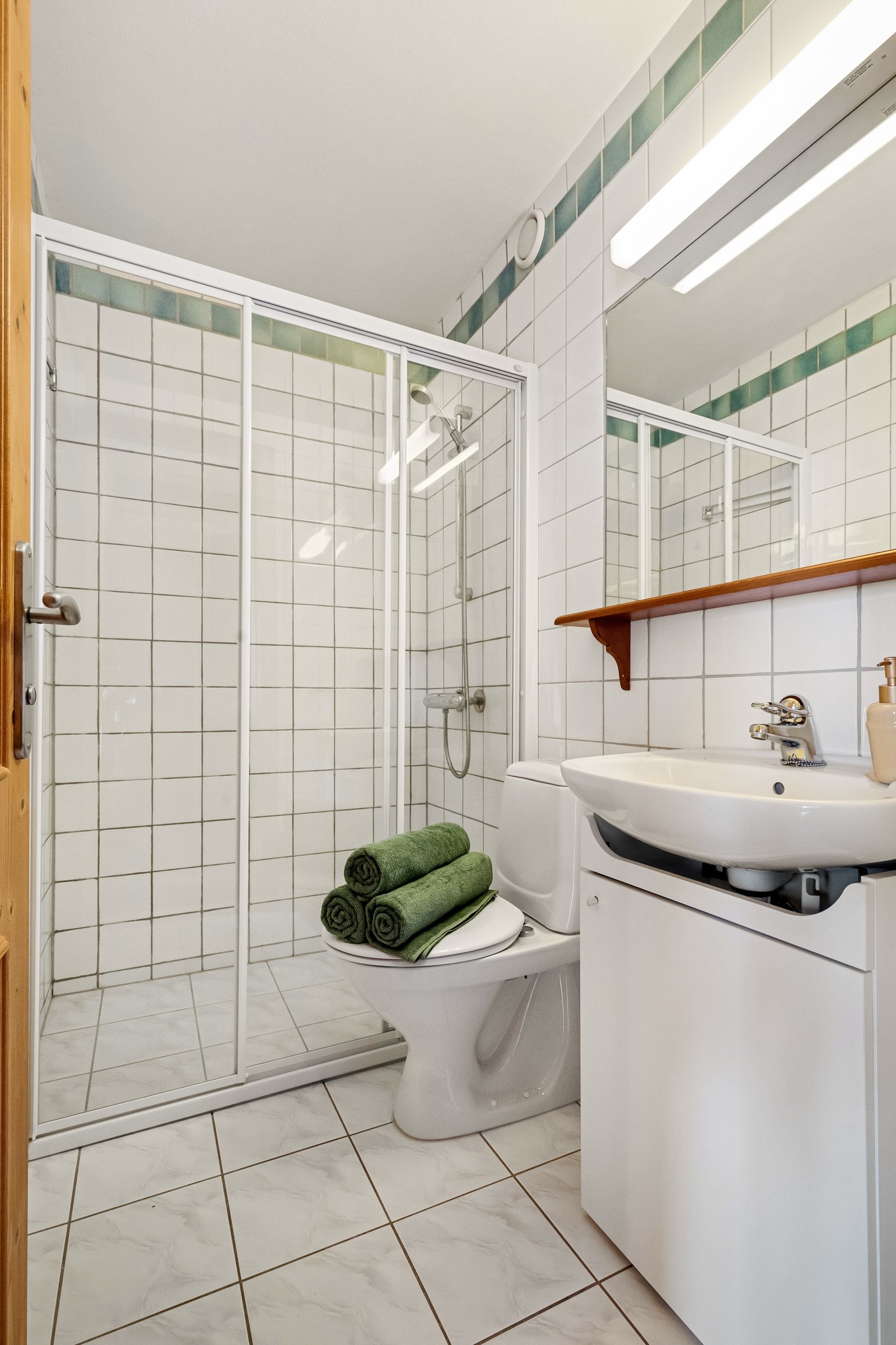 Enkel innredning med servant, toalett og dusjnisje med skyvedør Galleribilde