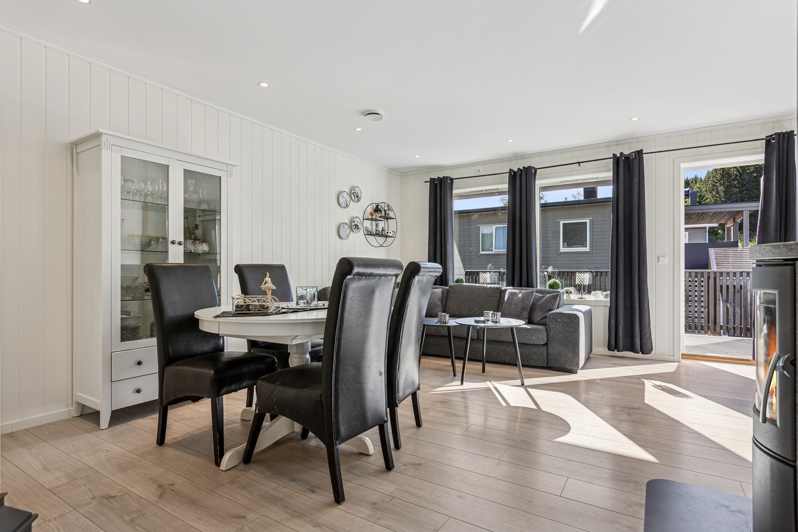 Den gode takhøyden og de gjennomgående, lyse overflatene gir rommet et elegant preg, mens laminatgulv og panelplater på veggene gir en tidløs og lun ramme. Galleribilde