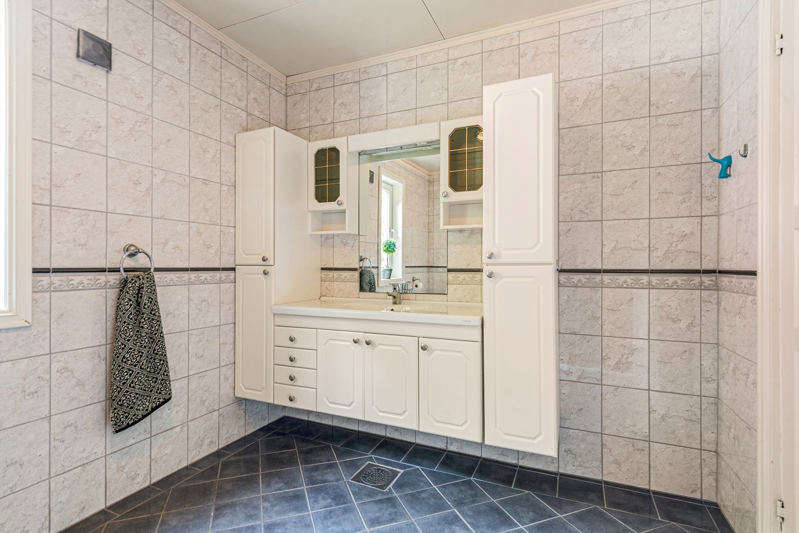 Stor og romslig innredning på bad med god skapplass Galleribilde