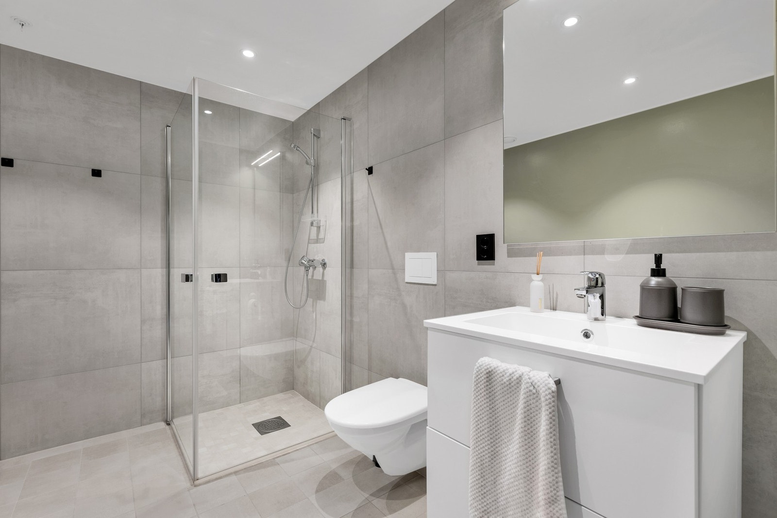 Meget lekkert flislagt bad måler 5,6 kvm. Her har du elektriske varmekabler i gulv og spotter i himling. Galleribilde