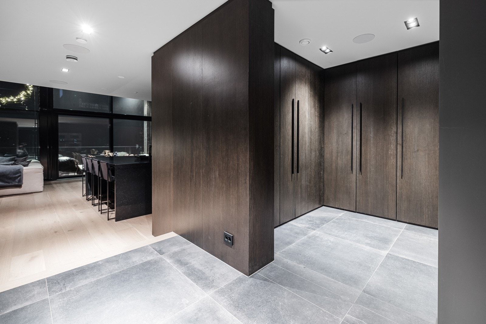 Romslig gang med stilren innredning og integrert belysning som skaper en lys og innbydende atmosfære.