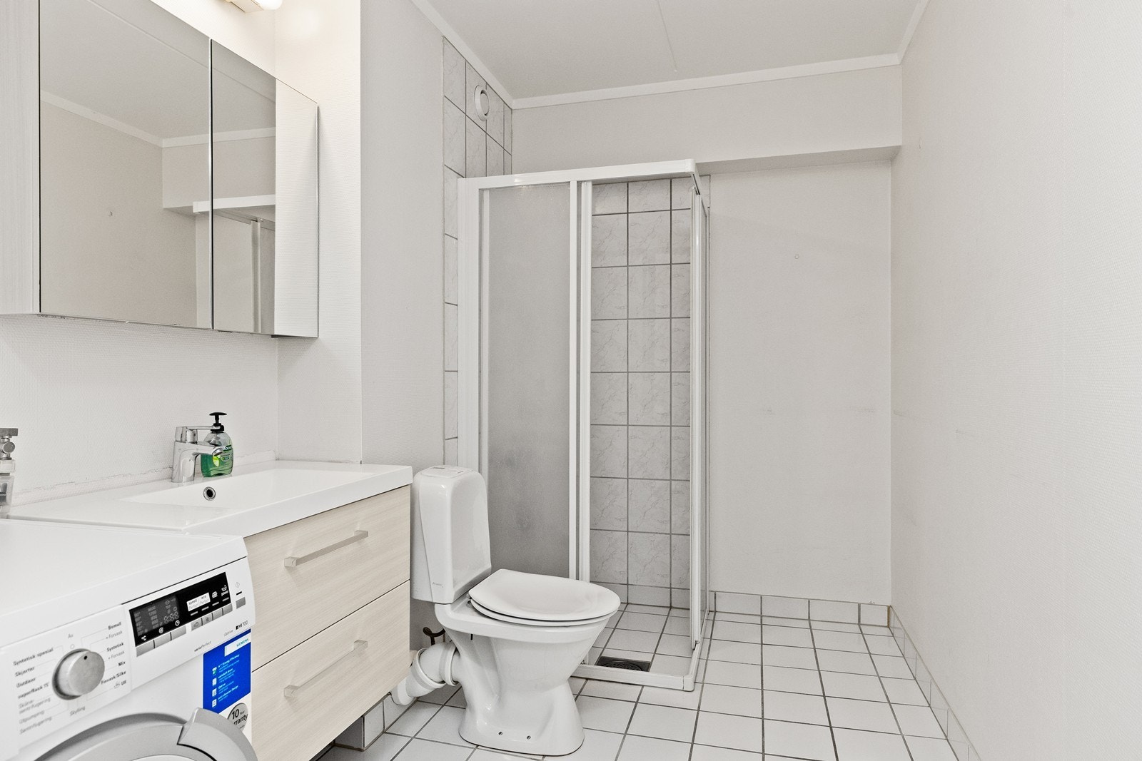 Badet har fliser på gulvet, samt på veggene i dusjhjørnet. Her er det varmekabel i gulvet. Galleribilde