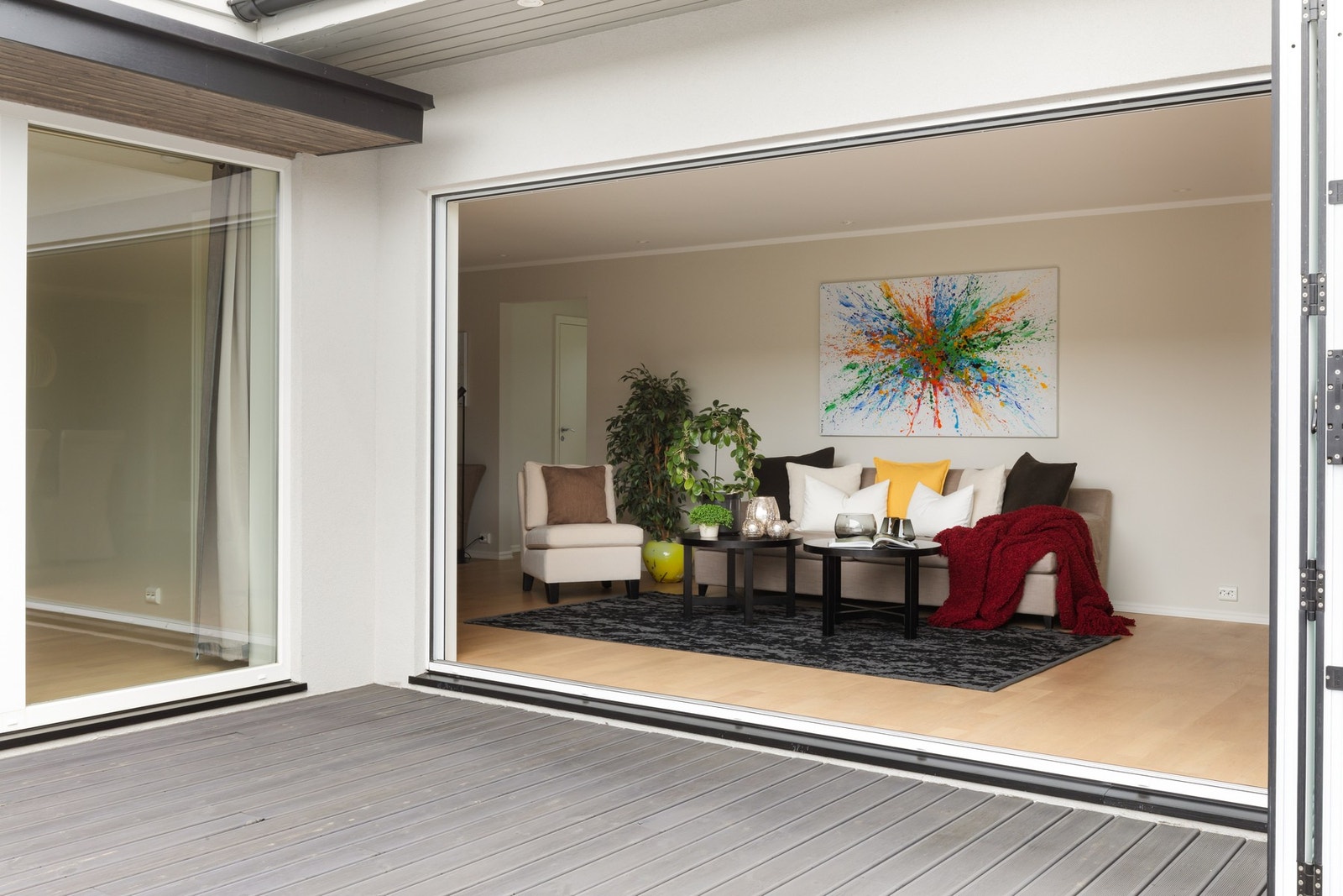 Foldedører åpner fra stue til uteplass. Galleribilde