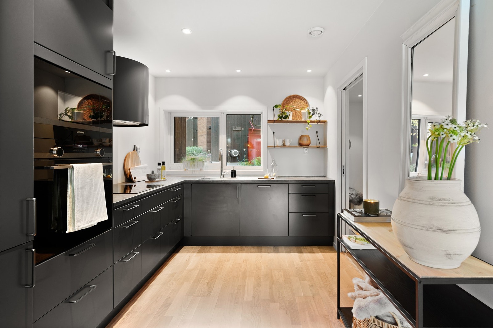 Påkostet kjøkken fra Drømmekjøkkenet med integrerte hvitevarer fra Siemens og avtrekksvifte fra Røroshetta. Galleribilde