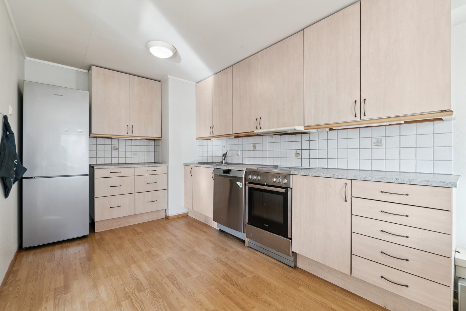 Kjøkkeninnredningen har lyse fronter og godt med oppbevaringsplass i skuffer og skap. Galleribilde