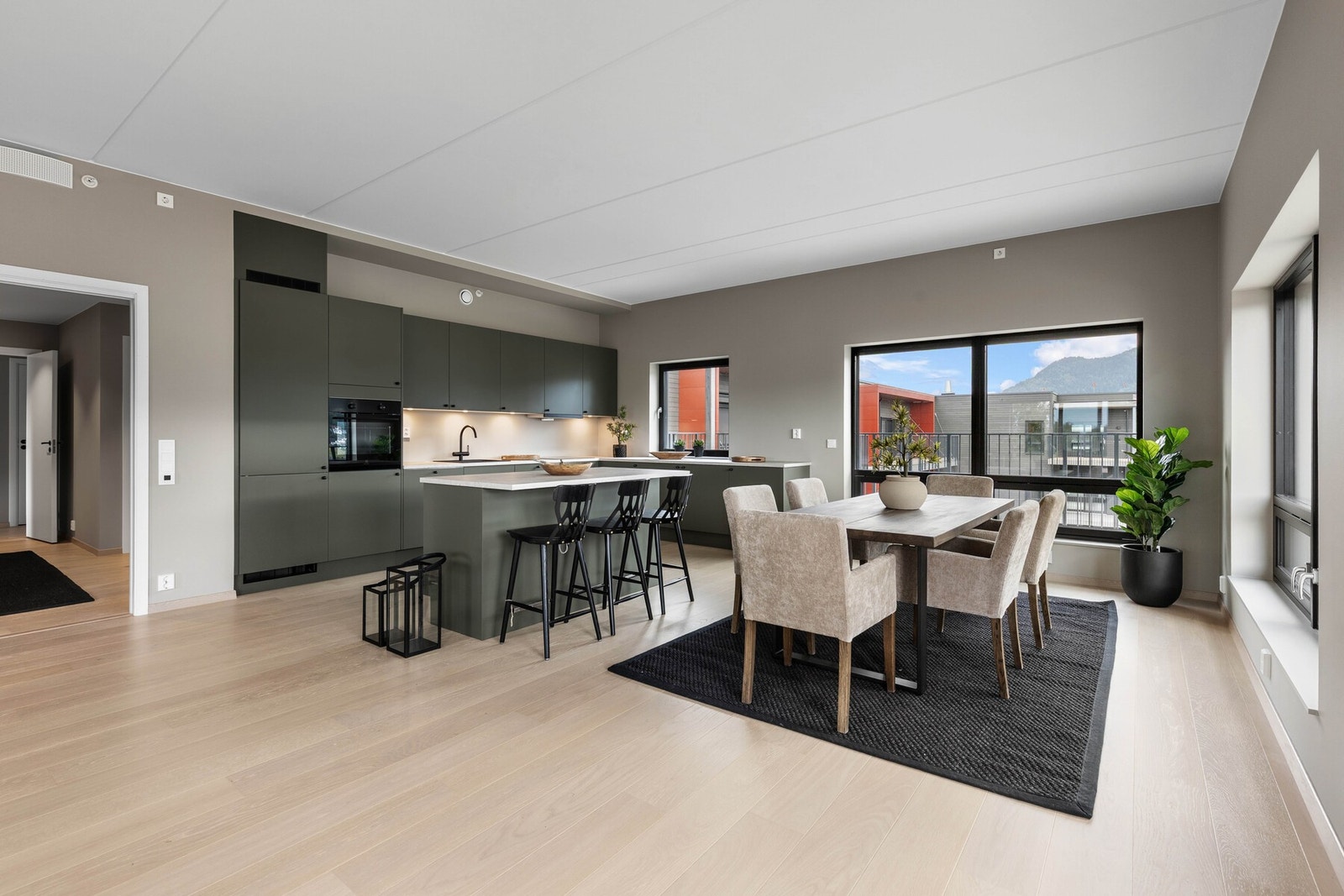 På motsatt side av stuen er det et stort kjøkken med tilhørende kjøkkenøy. Galleribilde