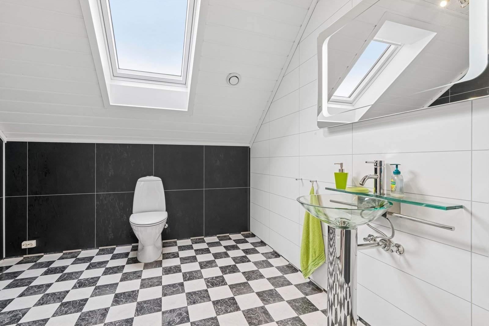 Innbydende bad med belegg på gulv og våtromsplater på vegg. Rommet har dusjkabinett, toalett og håndvask. Våtrom har ventilasjon via mekanisk avtrekk. Takvindu som gir godt med lysinnslipp. Galleribilde