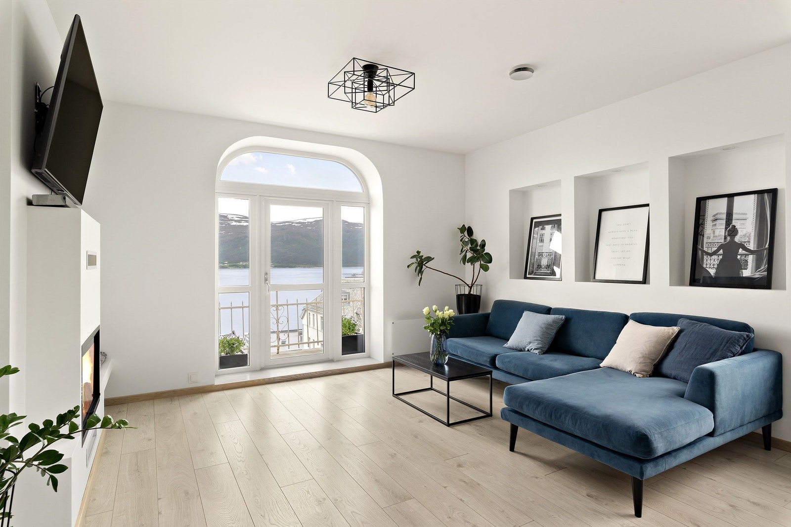 Stuen er åpen og lys med store vindusflater og utgang til balkong Galleribilde