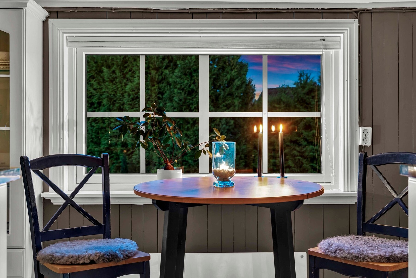 Fra frokostbordet har man utsikt over hagen og tomten Galleribilde