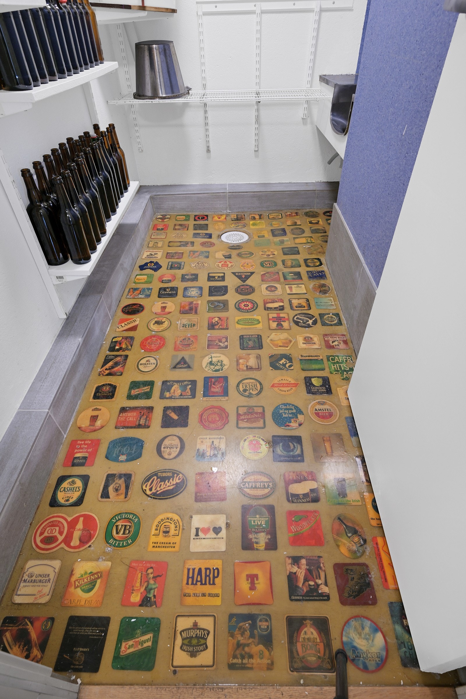 Spesialgulv i klar epoxy med ølbrikker fra diverse reiser Galleribilde