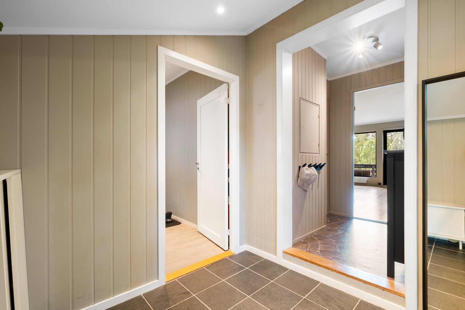 En romslig entré med plass til oppbevaring til ytterbekledningen. Det er adkomst til innendørs bod benyttet som treningsrom. Galleribilde