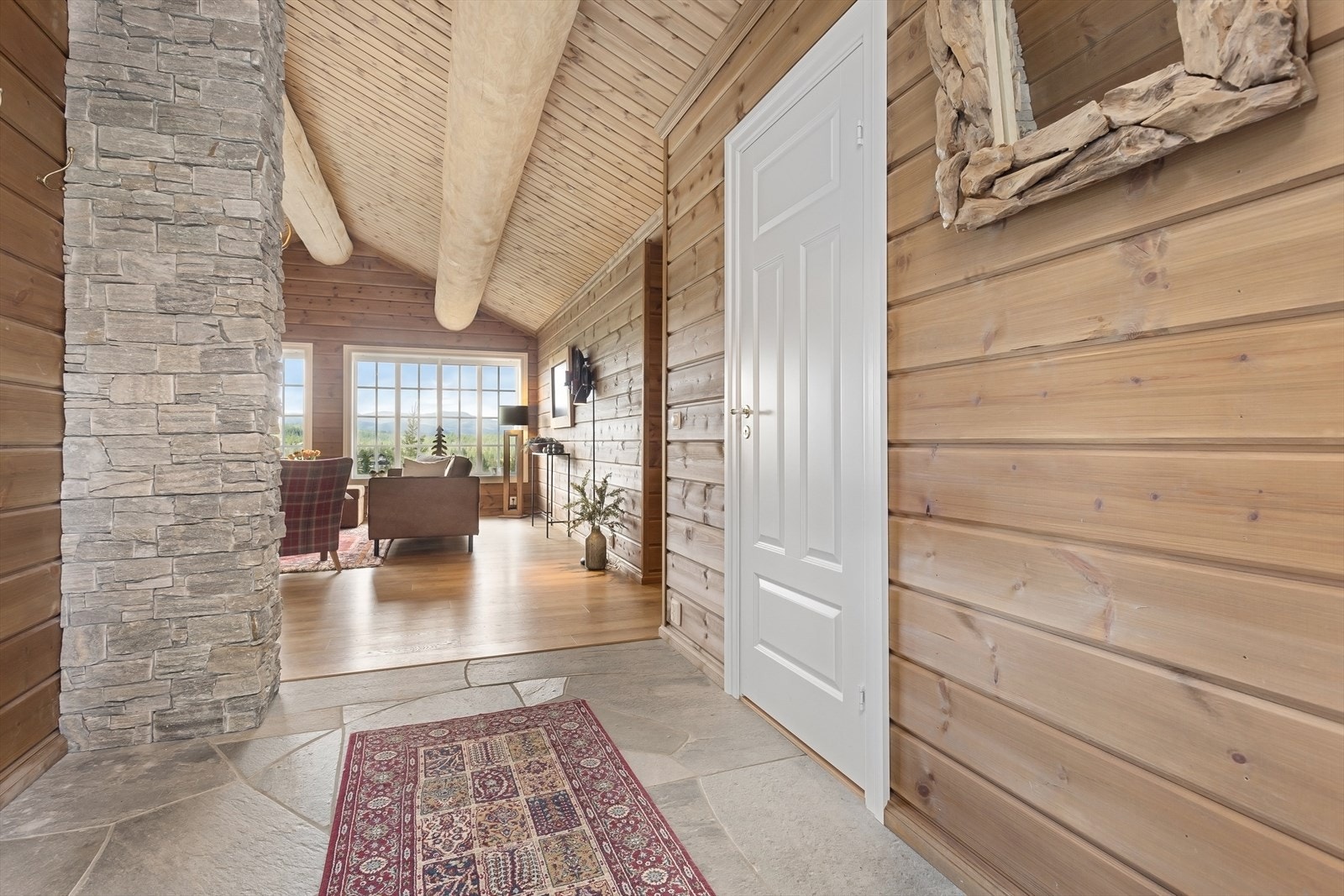 Fra entré er det direkte adkomst inn til stuen, noe som skaper en naturlig og sømløs flyt i hytta. Galleribilde