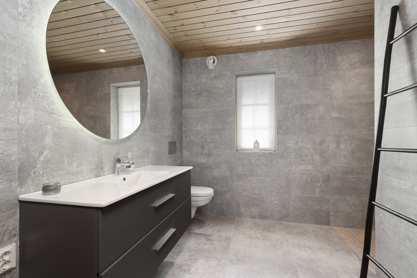 Badet har et moderne og innbydende design med flislagte vegger og gulv med elektriske varmekabler. Galleribilde