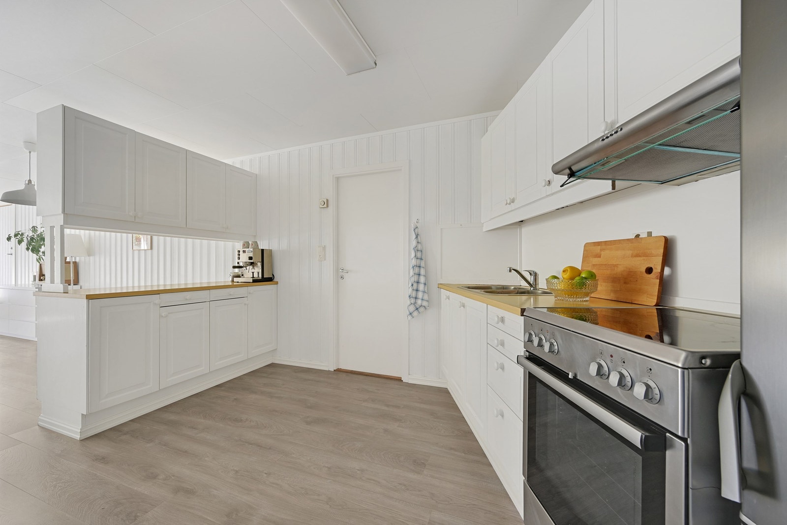 Fin kjøkkenløsning med rikelig med skap- og benkeplass Galleribilde