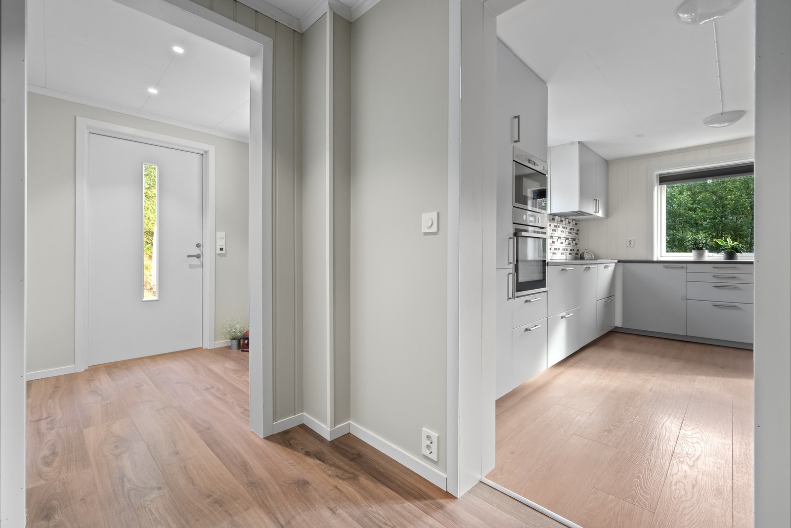 Entre med plass til skyvedørsgarderobe og praktiske løsninger for oppheng av yttertøy. Galleribilde