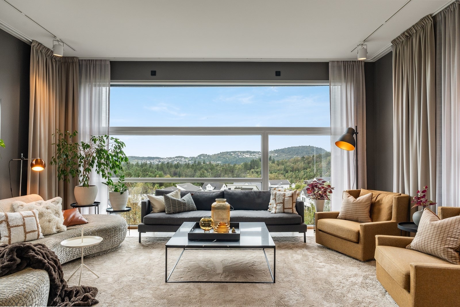 Herlig stue med generøse og store vindusflater hvor en får rikelig med lysinnslipp Galleribilde