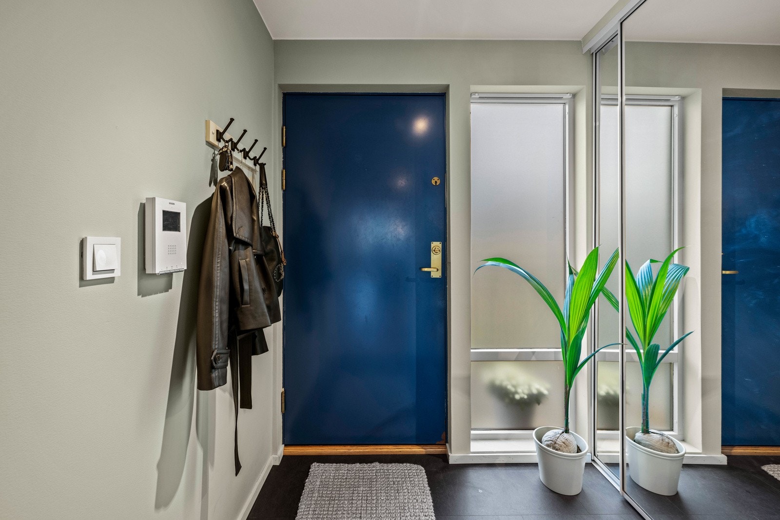 Romslig entré med fliser på gulvet med varme og integrert skyvedørsgarderobe. Galleribilde