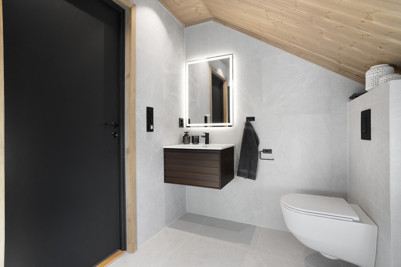 Lekkert barderom med veggmontert toalett, innredning med servant og dusjhjørne Galleribilde