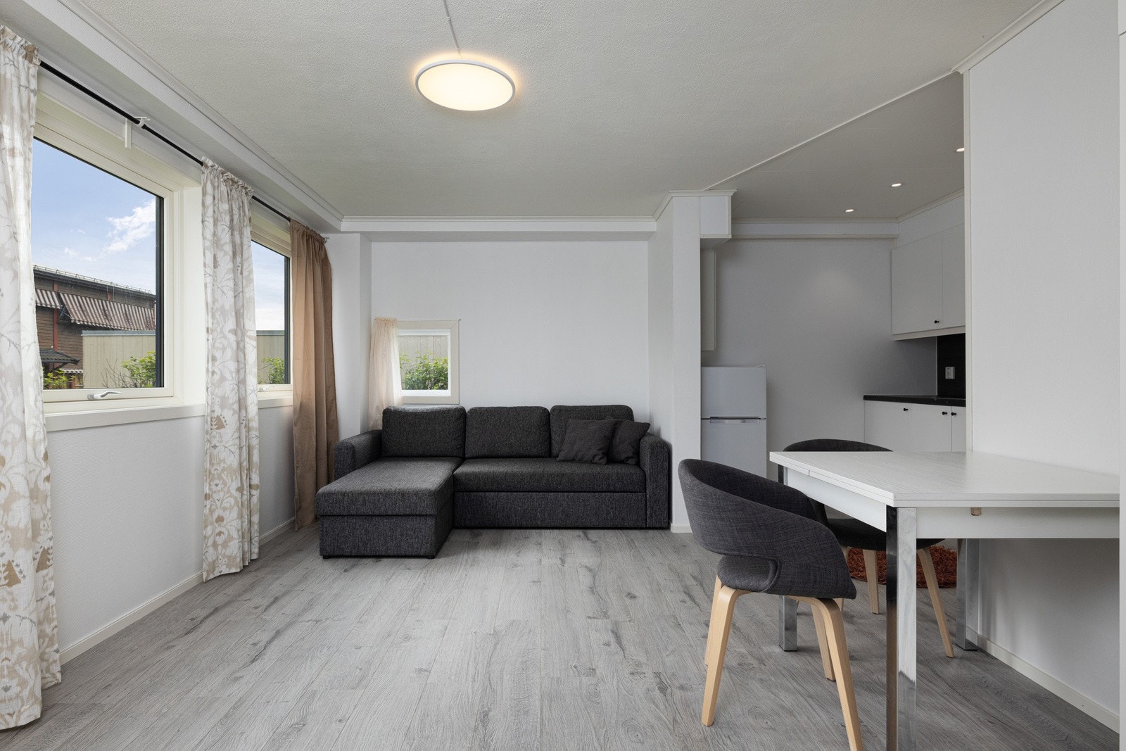 Videre finner du en romslig stue med god plass for møblering av sovesofa og spisebord, samt tv og tv-bord. Galleribilde