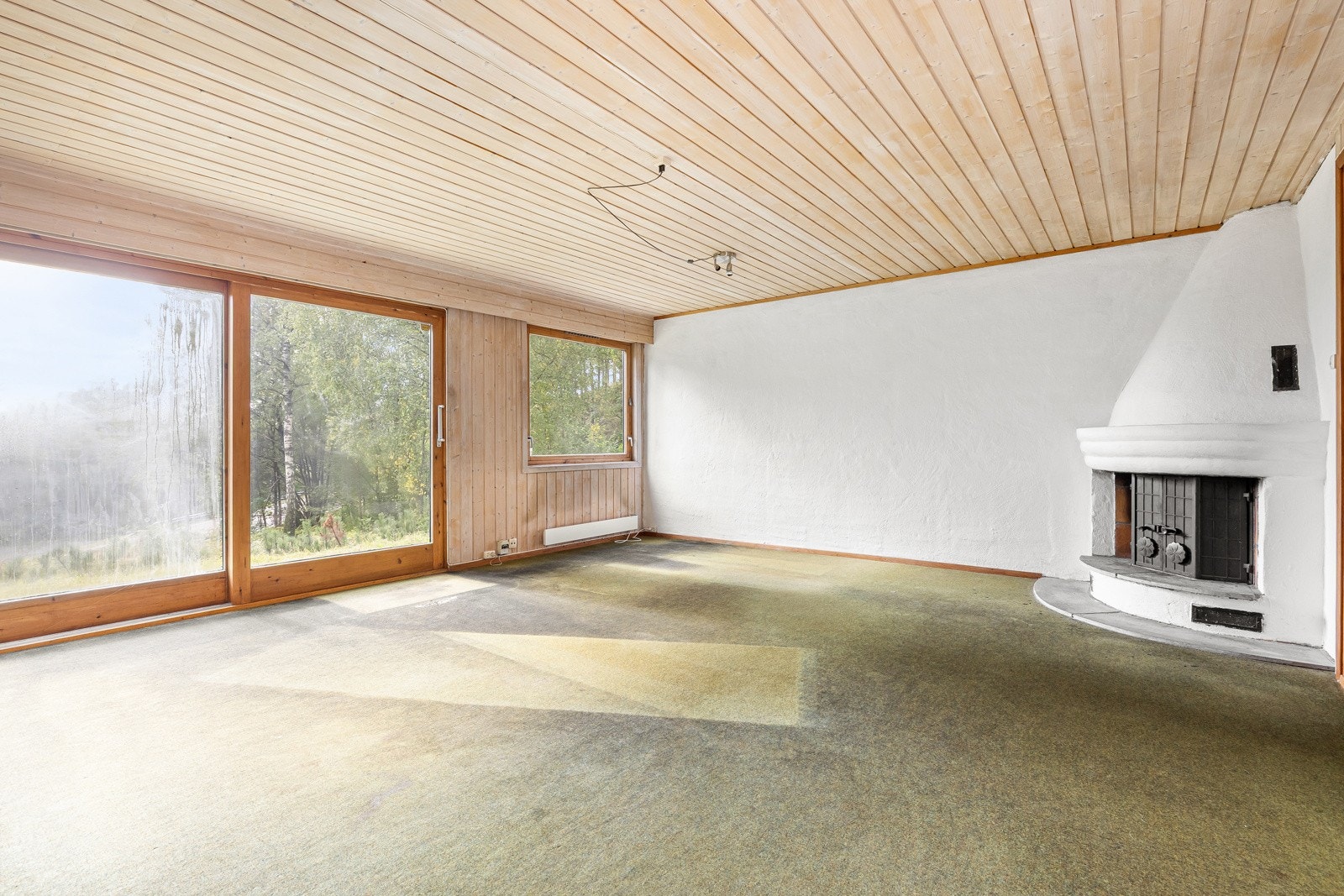 Romslig kjellerstue med store vindusflater og utgang til sydvent hage. Galleribilde