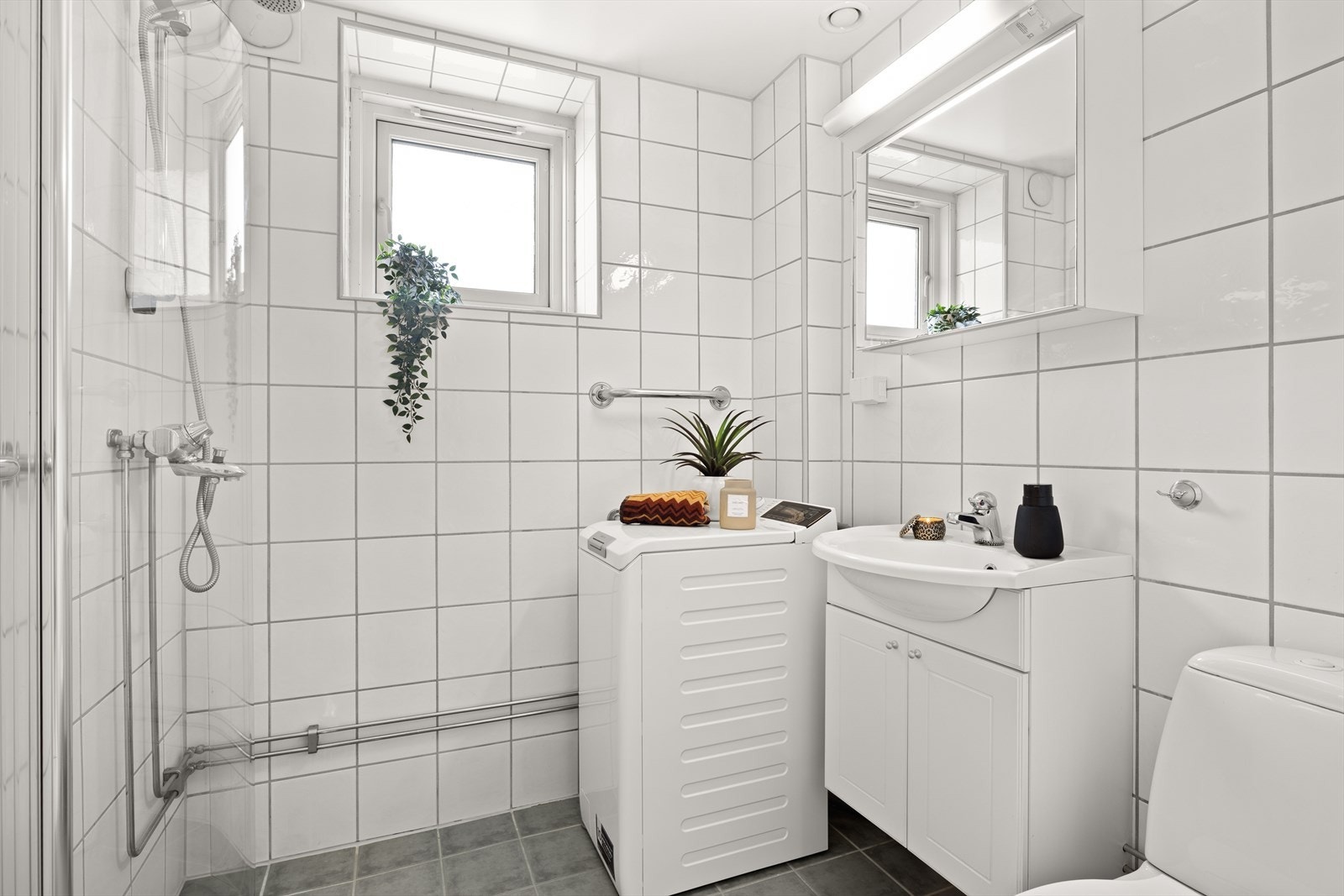 Pent flislagt bad fra 2006 i regi av borettslaget. Badet har opplegg for vaskemaskin, servant med innredning, dusjhjørne og toalett. Galleribilde