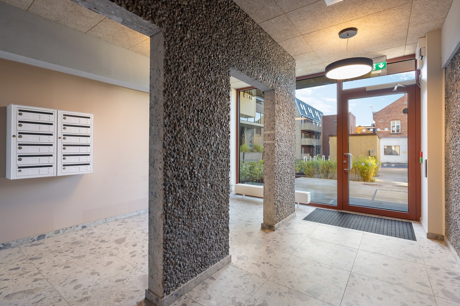 Inngang fra bakkeplan. Leiligheten disponerer egen sportsbod i felles kjeller og egen, asfaltert biloppstillingsplass. Galleribilde