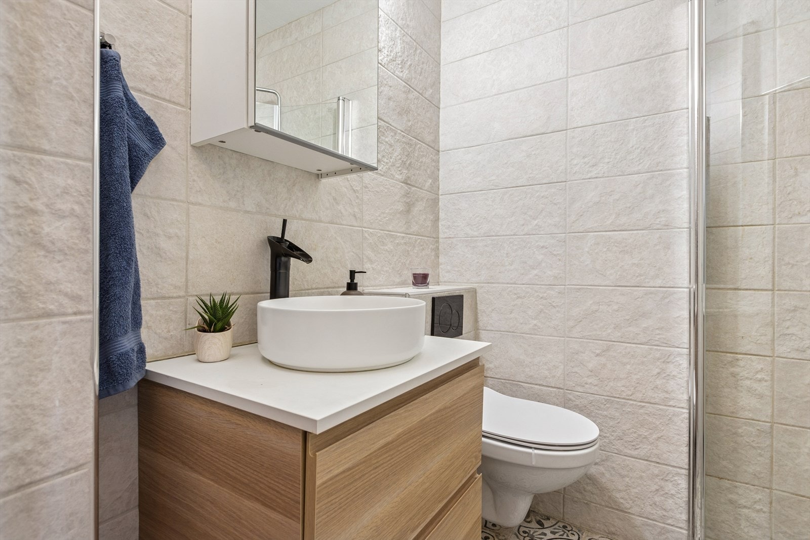 Pent, flislagt baderom. Flis på gulv og vegg, malt slett himling. Det er etablert et eldre sluk av soil/støpt Galleribilde