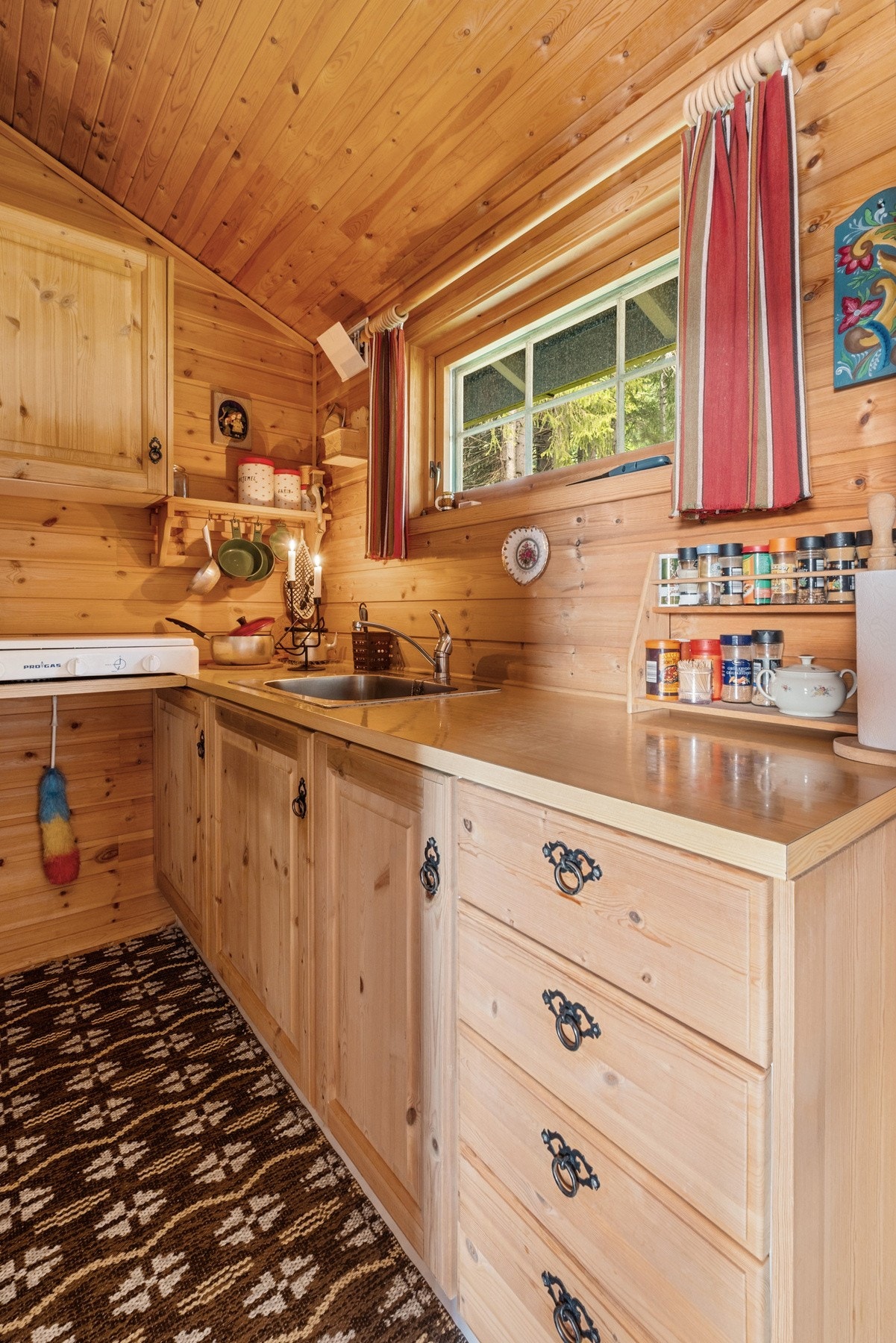 Kjøkkeninnredning med profilerte, finerte fronter og benkeplate med nedfelt servant. Galleribilde