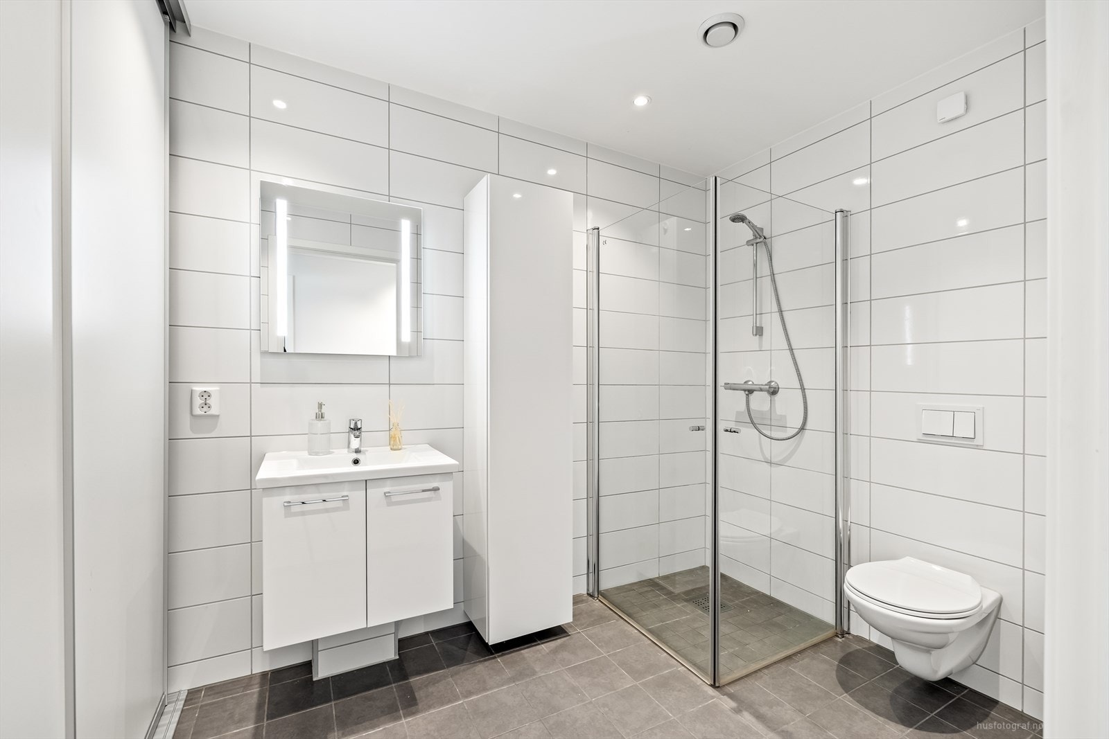 Badet i 1.etasje ligger praktisk i tilknytning til soverommene og er lekkert, med moderne farge- og materialvalg. Galleribilde