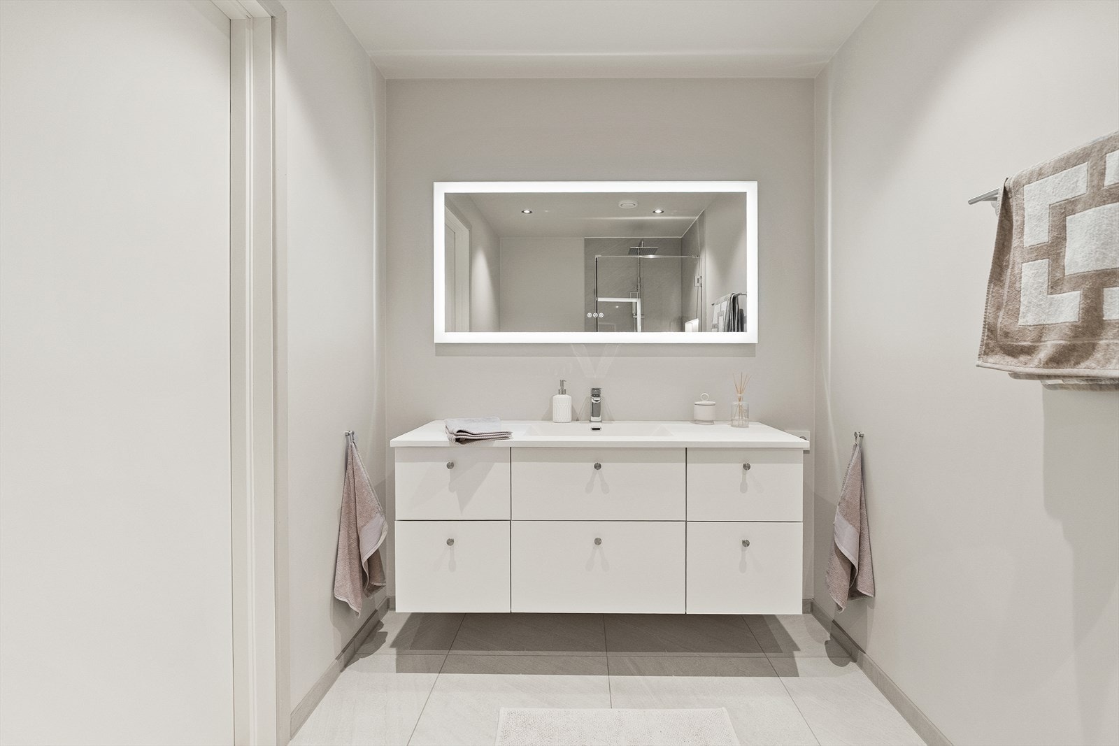 Badet er utstyrt med speil med høyttaler, varme i gulvet og moderne belysning for en behagelig atmosfære. Galleribilde