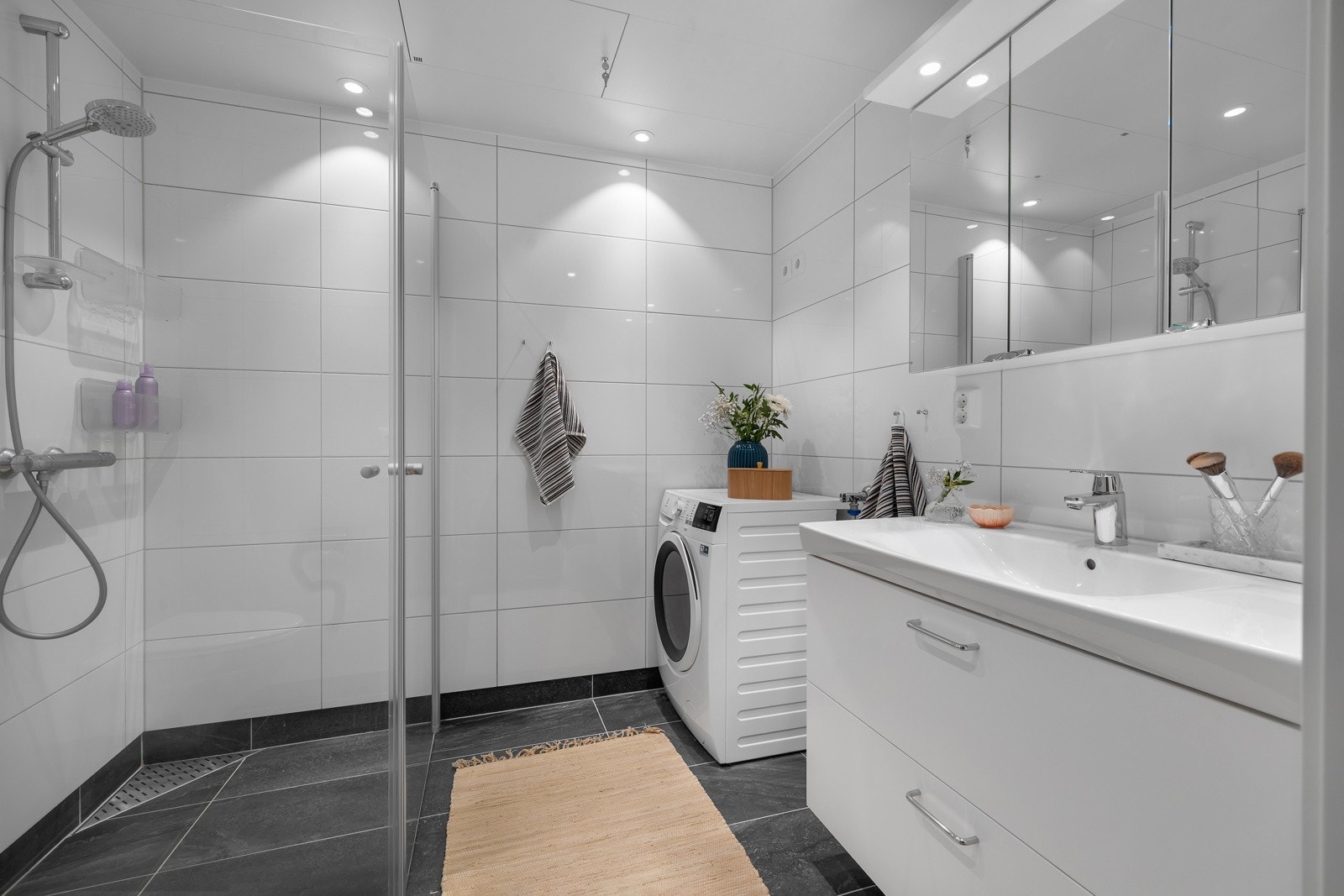 Dusjhjørne, wc, opplegg til vaskemaskon og servant med over/underskap. Galleribilde