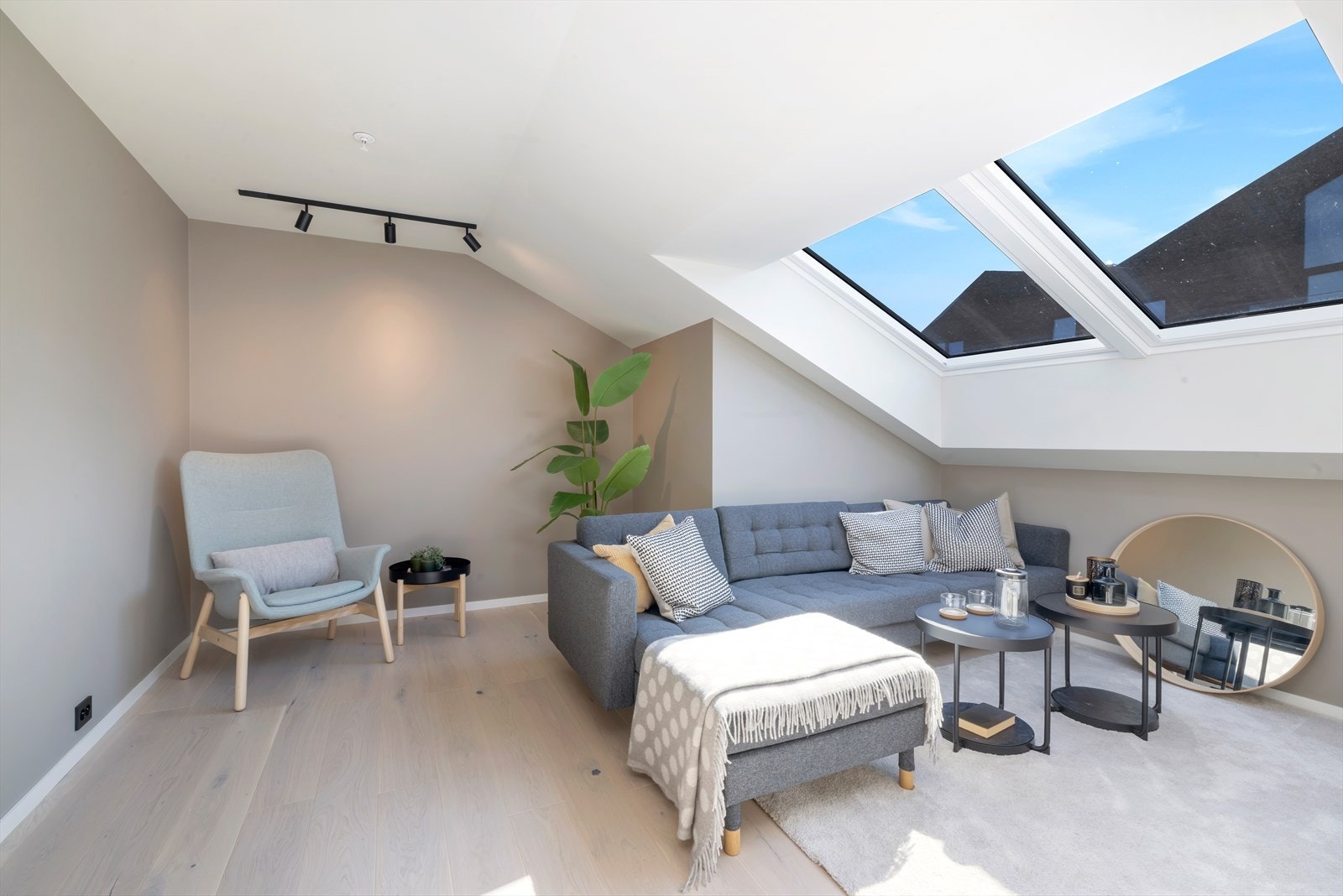 Koselig stue med takvindu som fyller rommet med dagslys, og plass til sofakrok for rolige stunder Galleribilde