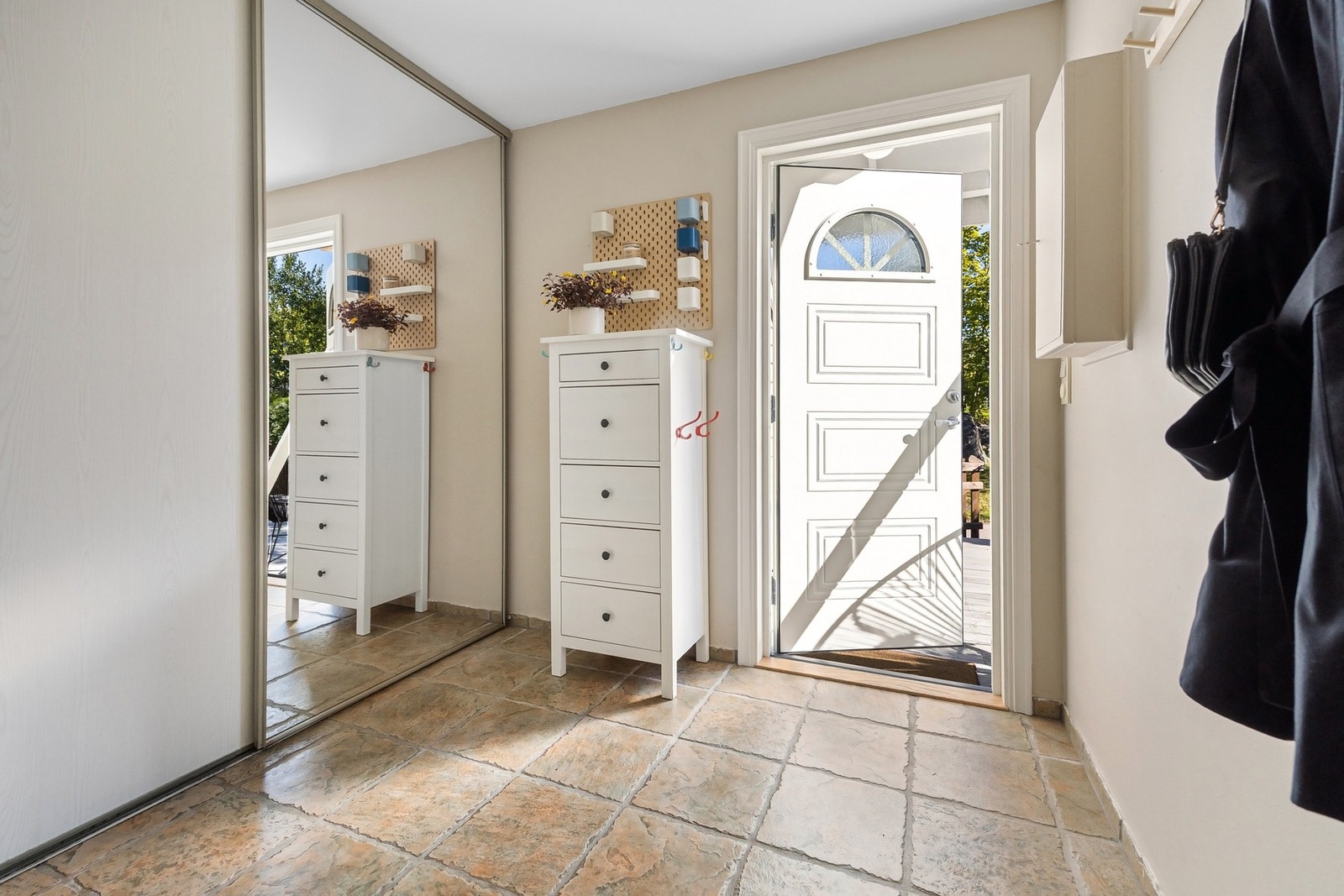 Det er montert praktisk skyvedørsgarderobe med god plass til ytterklær og sko Galleribilde