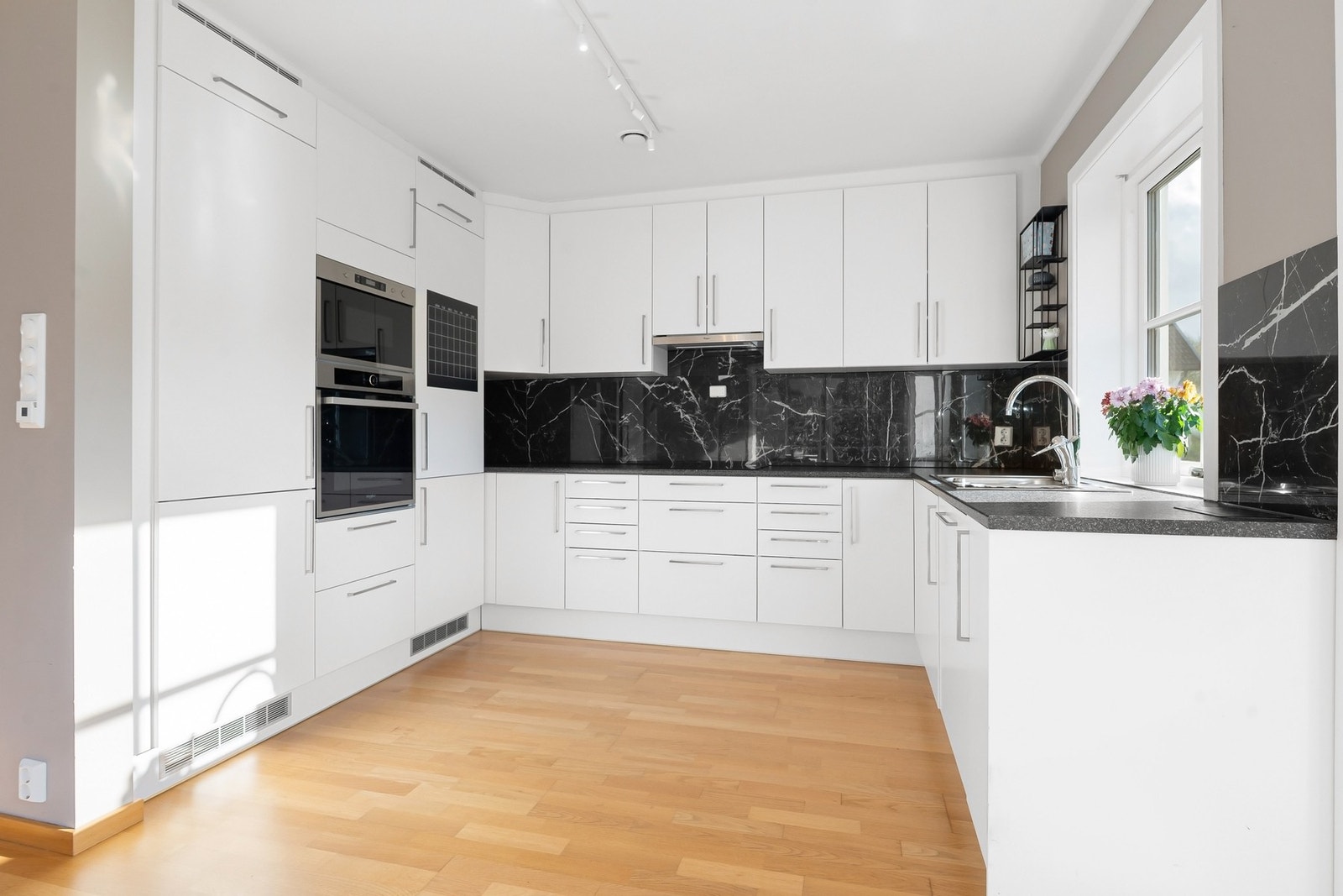 Romslit kjøkkeninnredning som godt med skap- og benkeplass. Galleribilde