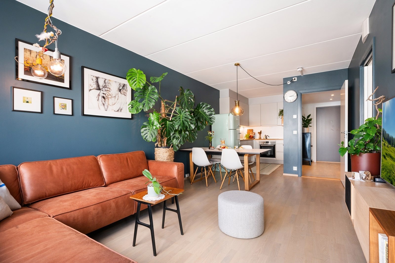 Den åpne løsningen mot kjøkkenet gir en sosial sone, hvor det er naturlig plass til spisebord mellom kjøkken og stue - perfekt for hyggelige måltider med familie og venner. Galleribilde