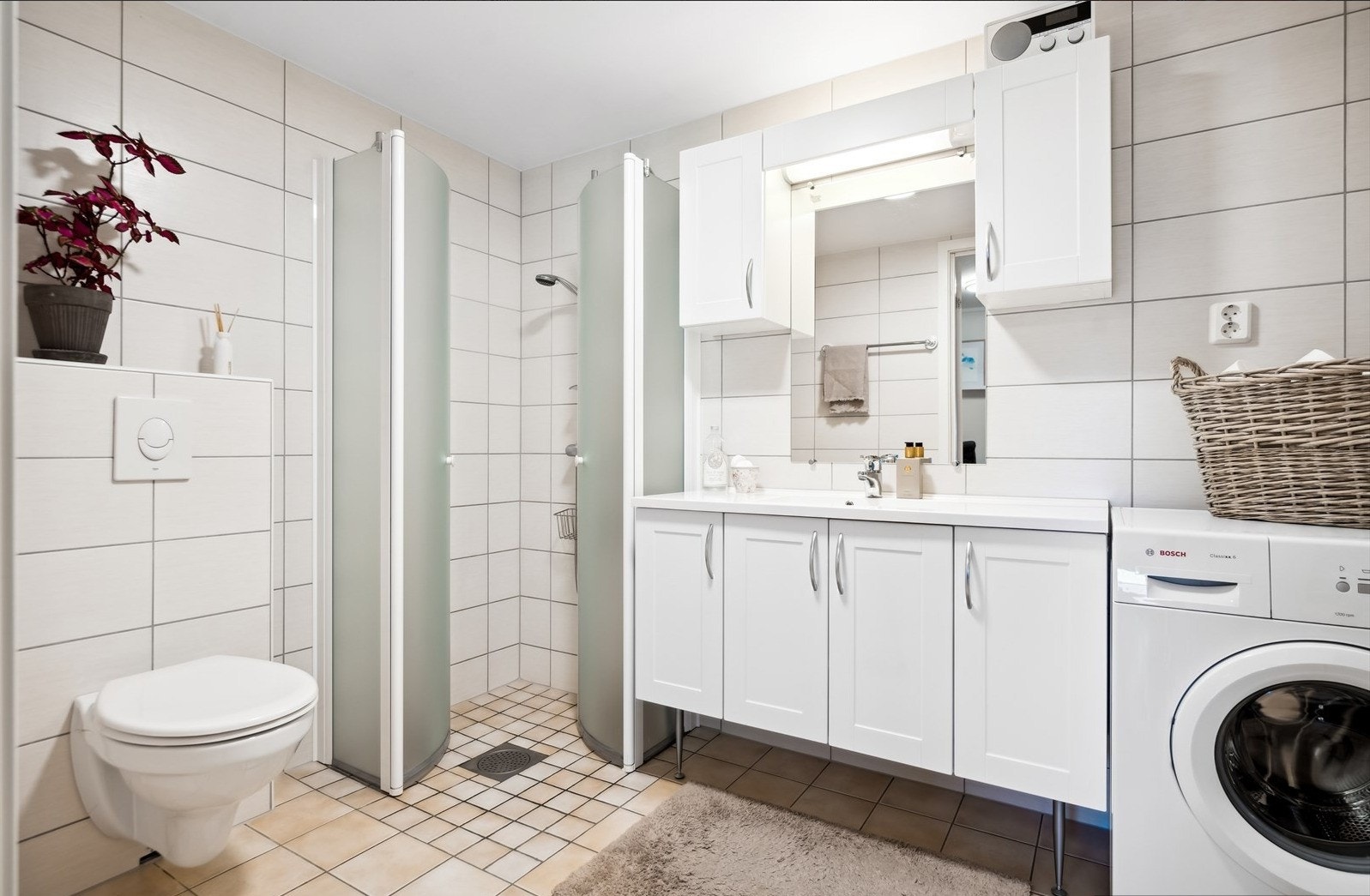 Veggmontert wc, dusjhjørne og opplegg for vaskemaskin/tørketrommel. Galleribilde