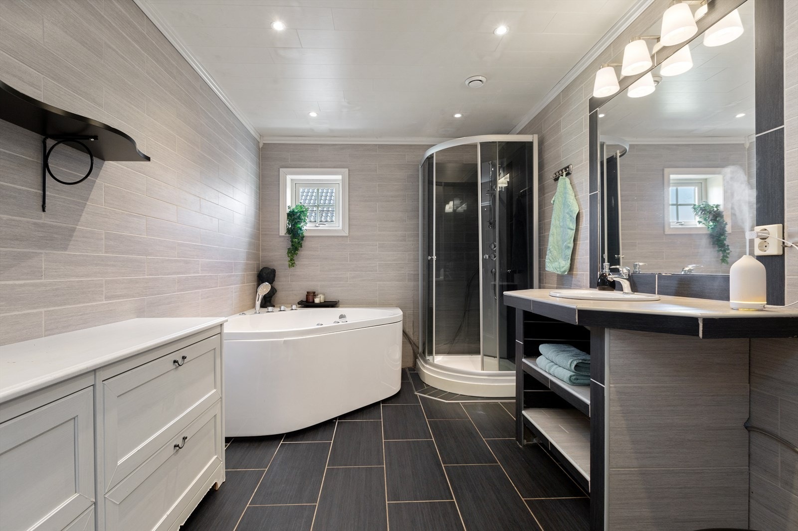 Romslig bad i første etasje med badekar og dusjkabinett. Galleribilde