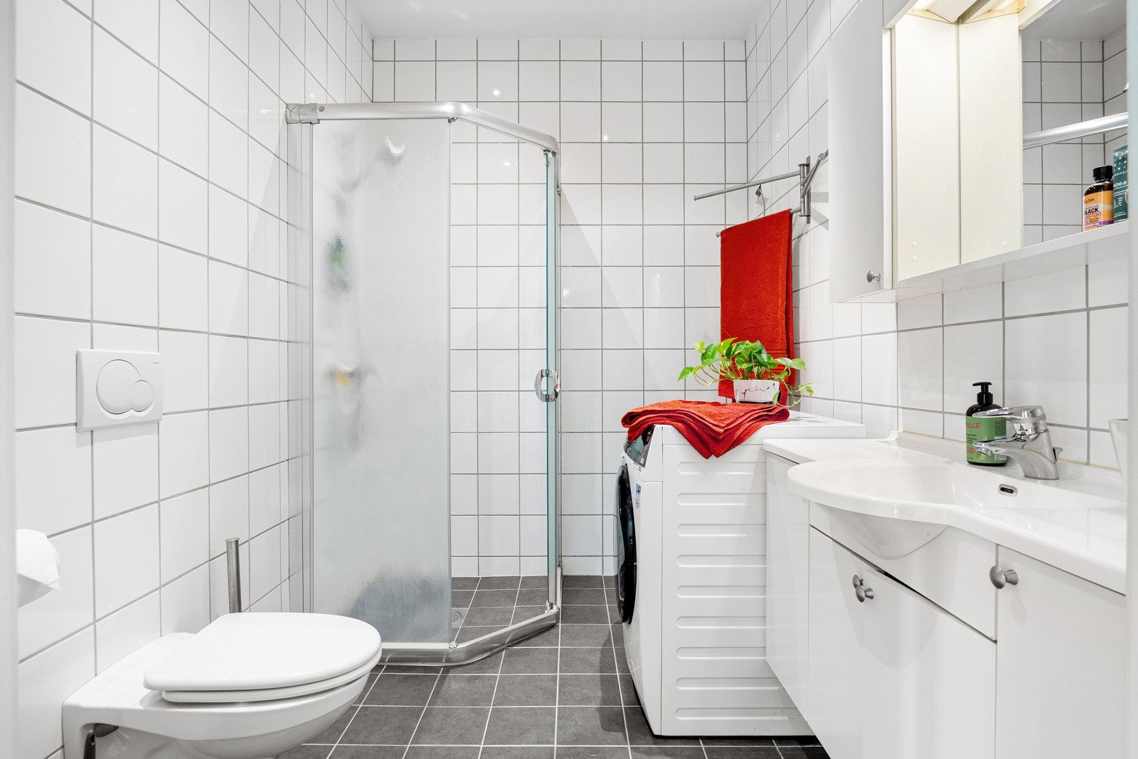 Lyst, åpent baderom med flislagte gulv- og veggflater Galleribilde