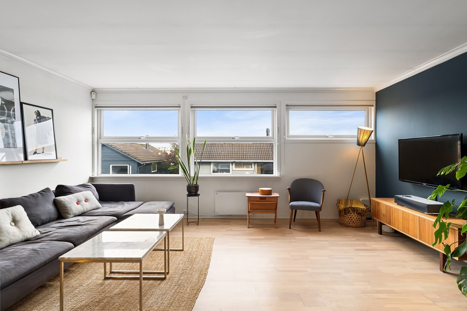 Lys og romslig stue med parkett på gulv, lysmalte flater og gode vindusflater Galleribilde