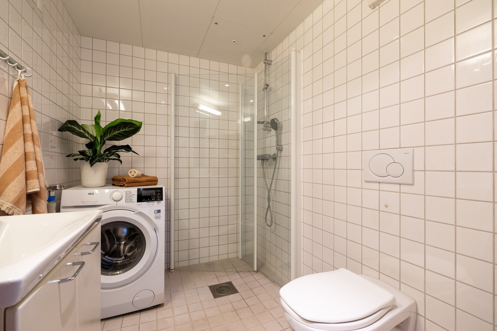 Baderommet er bygget opp med lyse fliser, har downlights i himling og varme i gulv. Galleribilde