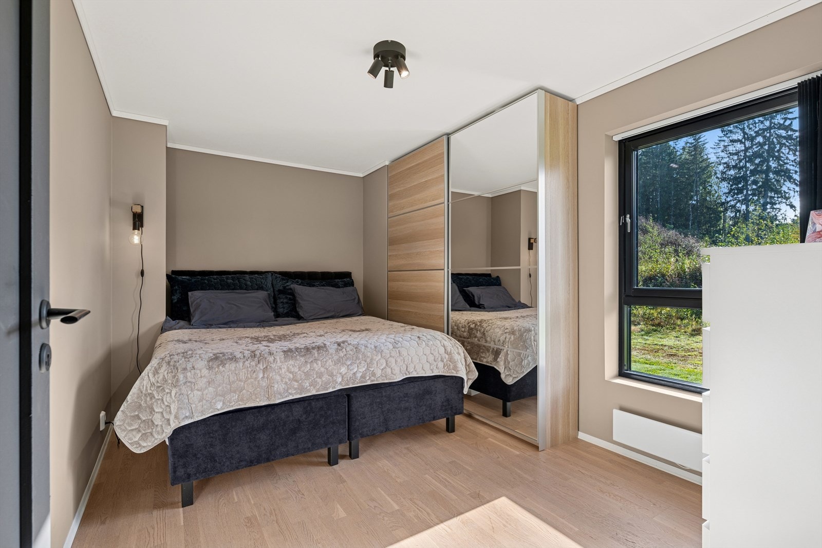 Lyst og luftig soverom med store vindusflater Galleribilde