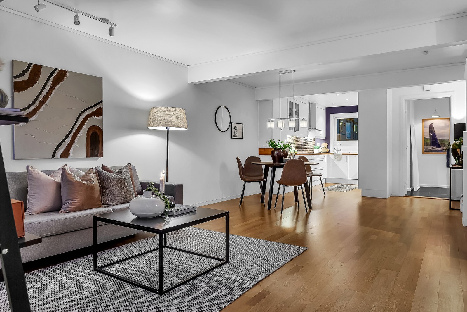 Den åpne løsningen mot kjøkkenet gjør rommet til et sosialt oppholdsrom med en behagelig atmosfære. Her får du et utmerket sted å invitere både venner og familien til hygge og gode måltider. Galleribilde