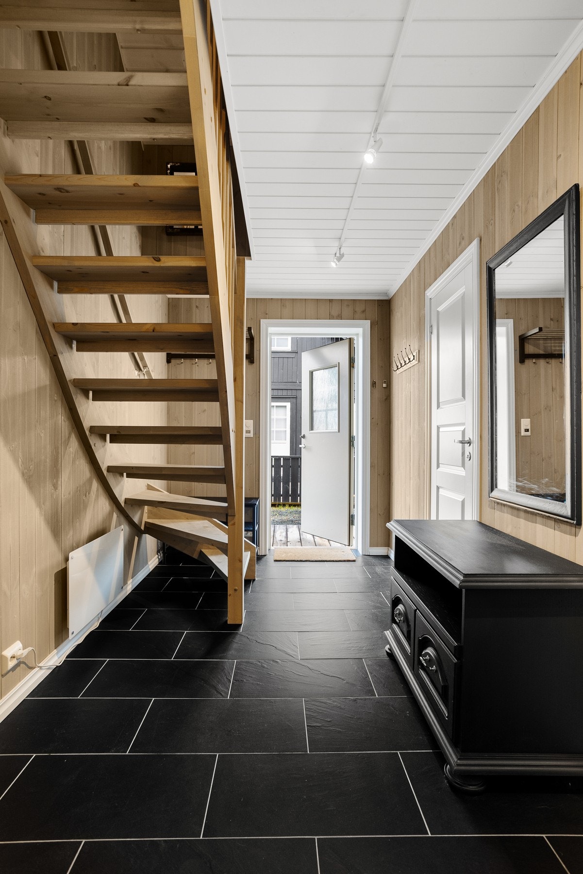 Innbydende entré med flislagt gulv og varmekabler. Her er det plass til å henge av seg yttertøy og sette fra seg sko. Galleribilde