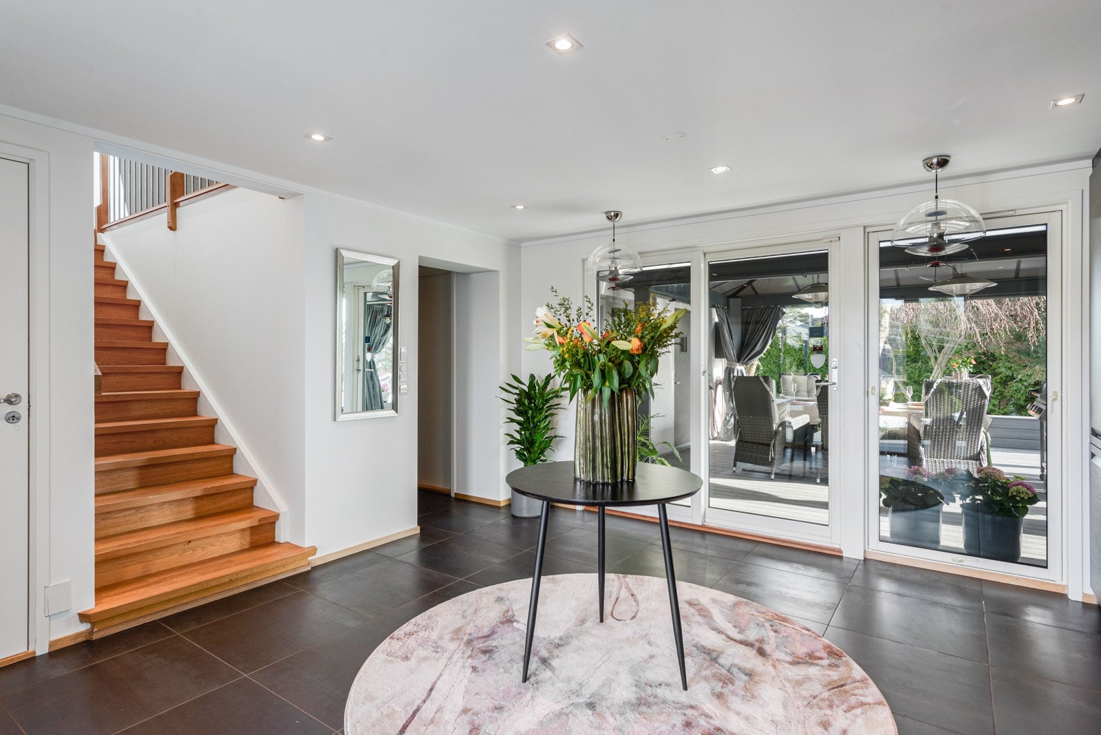 Stor hall med trapp til 2. etg. Utgang til uteområde og inngang til soveromsavdeling med 3 soverom Galleribilde