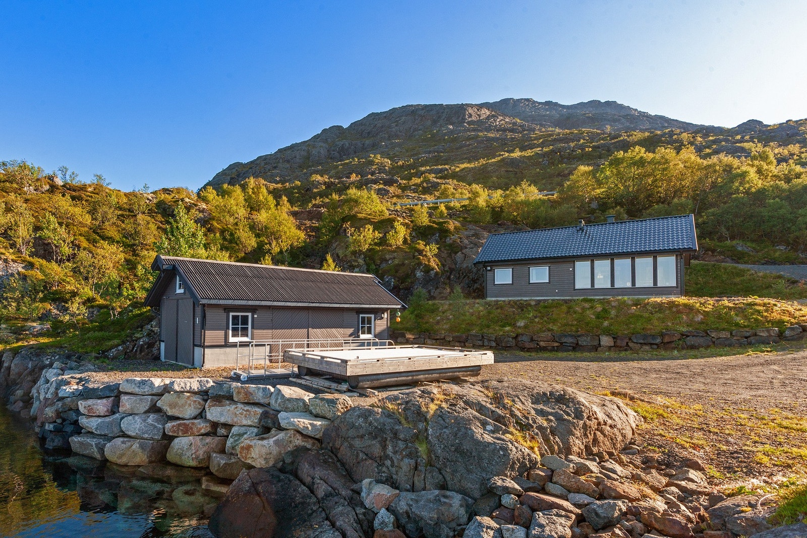 Eiendommen inkluderer hytte og stort naust bygget i 2017. Galleribilde