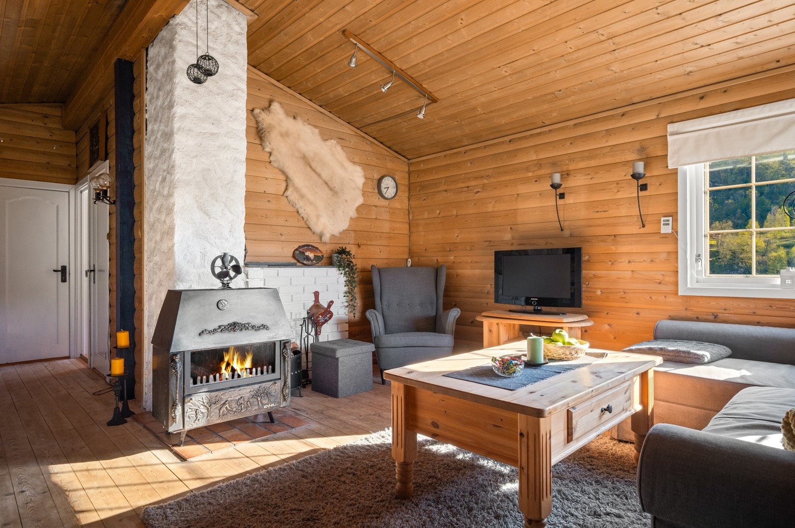 Hytta har innlagt elektrisitet og vedovn i stuen. Galleribilde