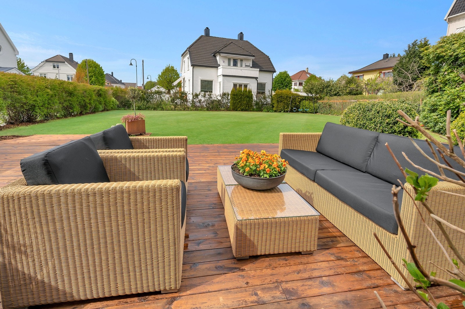 Sjeldent stor, flott og solrik hage med gressplen og platting Galleribilde