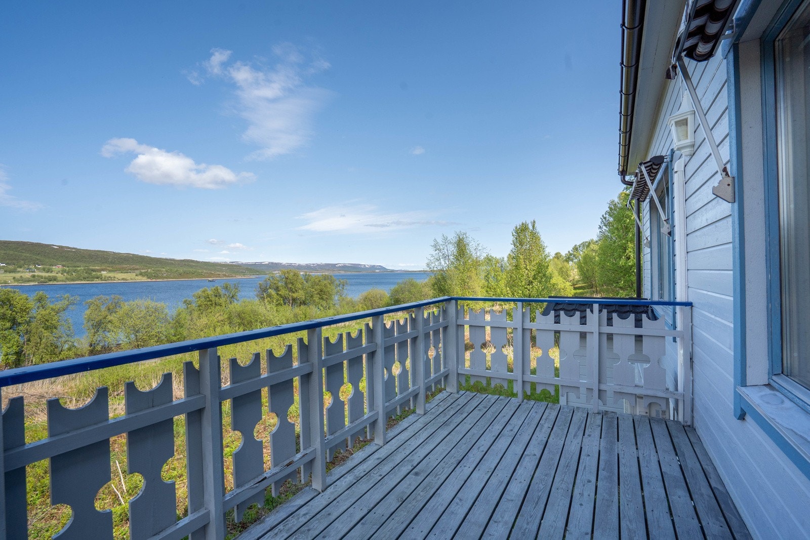 Boligen har markiser og varmepumpe montert på vegg og en nydelig utsikt fra verandaen Galleribilde