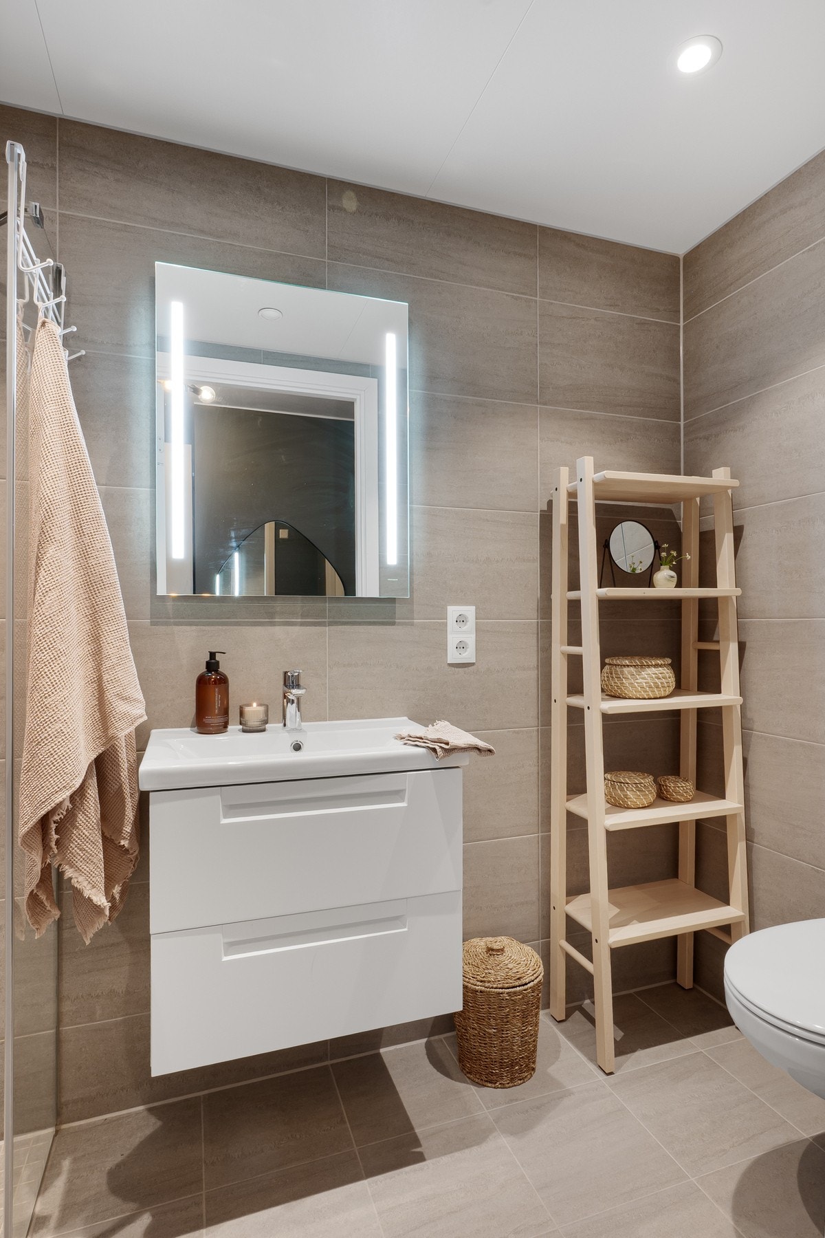 Baderommene holder en høy standard med helfliset utførelse, vegghengt toalett, dusjhjørne med glassdører og oppvarmede gulv. Galleribilde